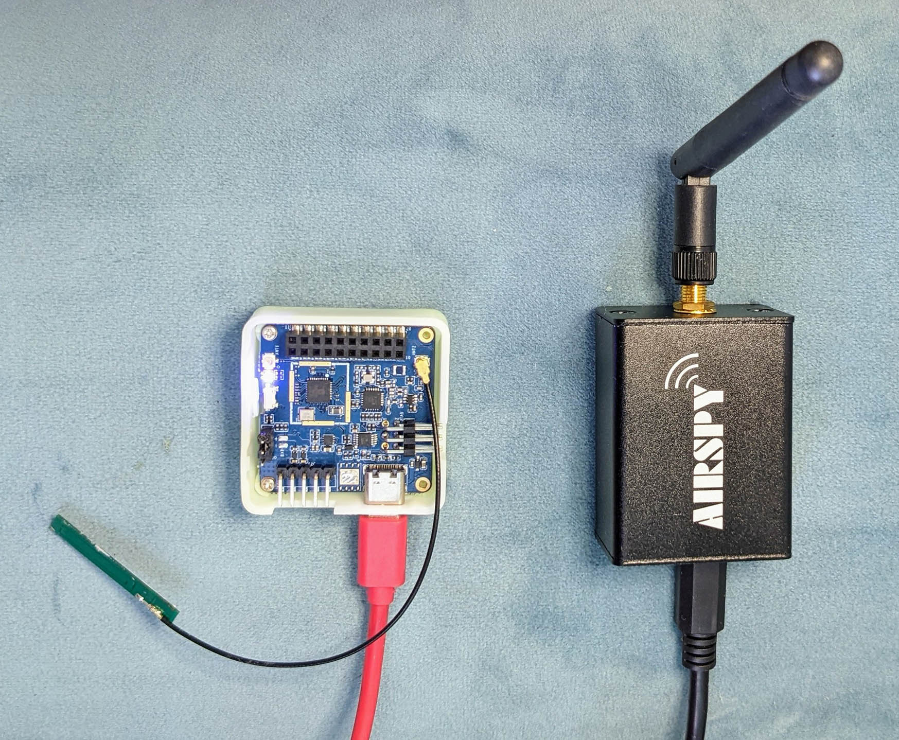 PineDio Stack BL604 RISC-V Board with onboard Semtech SX1262 LoRa Transceiver (left)… Sniffed wirelessly with Airspy R2 Software Defined Radio (right)